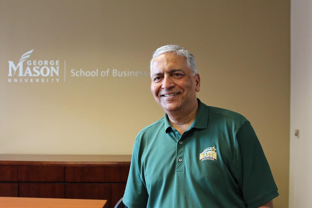 Dean Ajay Vinze posing in School of Business conference room.