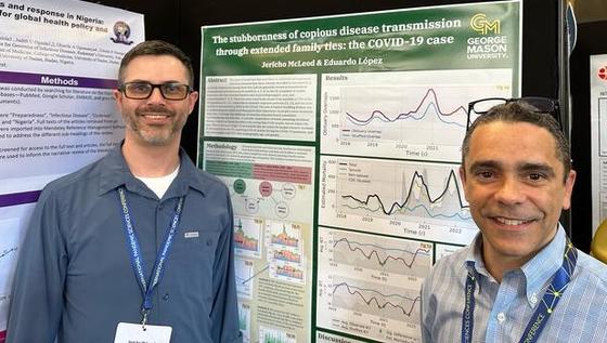 McLeod and Lopez at conference with poster