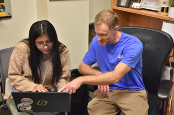 Student Alejandra Villanueva sits down for one-on-one coaching during FedWriters Takeover Day. Photo by Greg Johnson